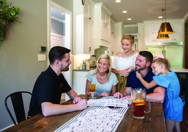 setting at the table looking brochure -a552845